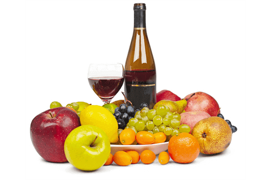 Bottle and glass of wine with fruits