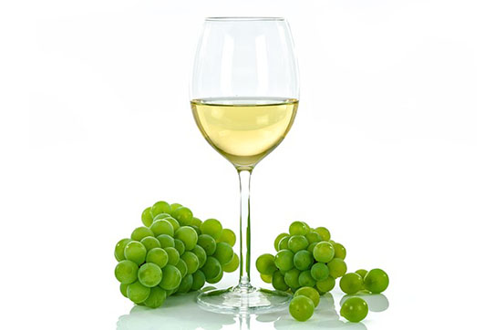 Glass of White wine with grapes
